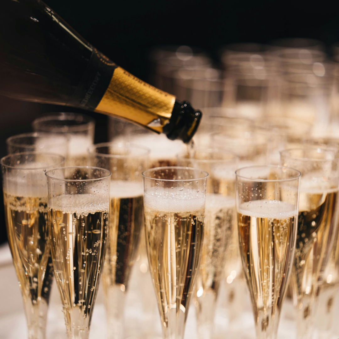Image: A row of flute glasses filled with a bubbly drink