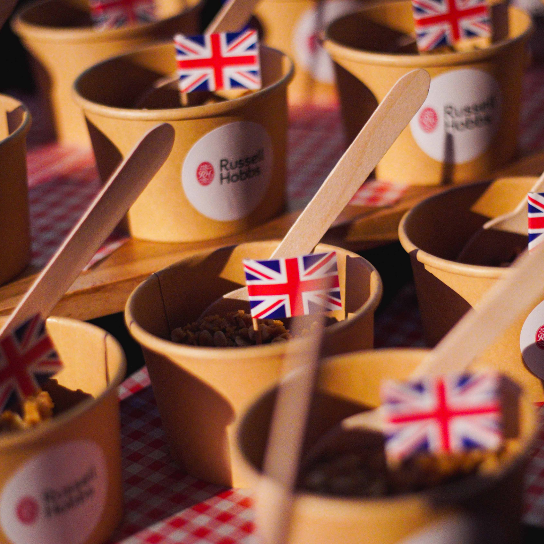 Image: A row of cups with a spoon and British flag. There is a stick on the cups that says RUSSELL HOBBS.