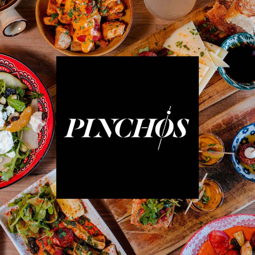 Text: Pinchos. Image: A variety of Spanish tapas food.